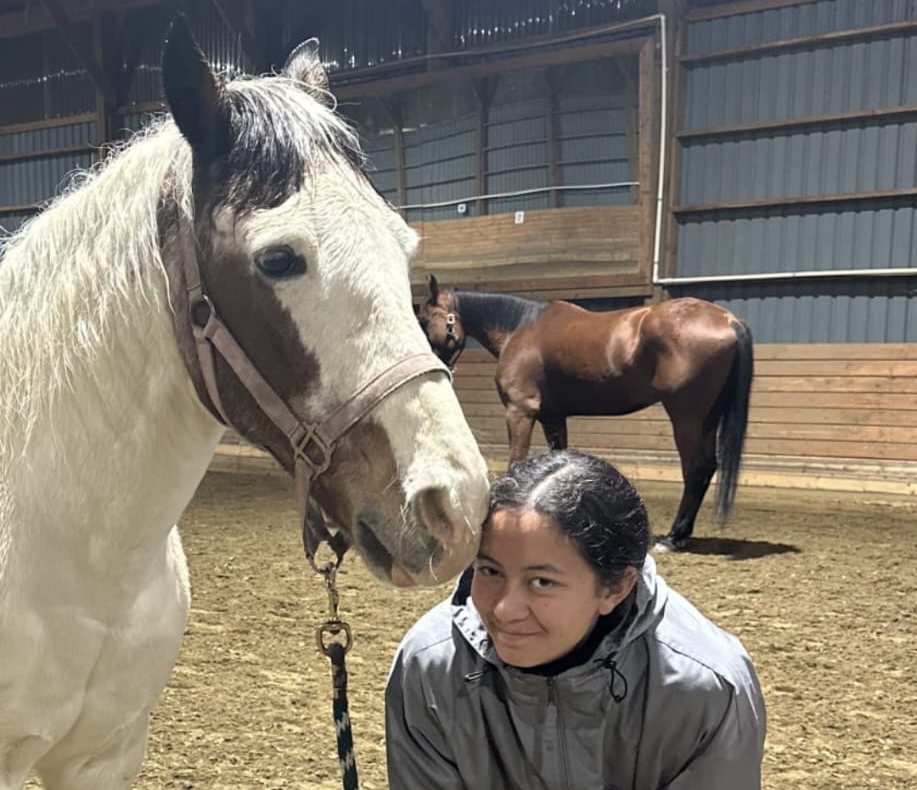Skippy, a 29 year old paint pony, with his owner in the arena